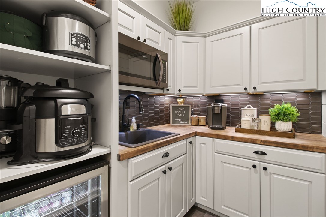 140 Gentry Road Boone, NC 28607 - Photo 27 of 49 a kitchen with stainless steel appliances granite countertop a sink a stove and cabinets
