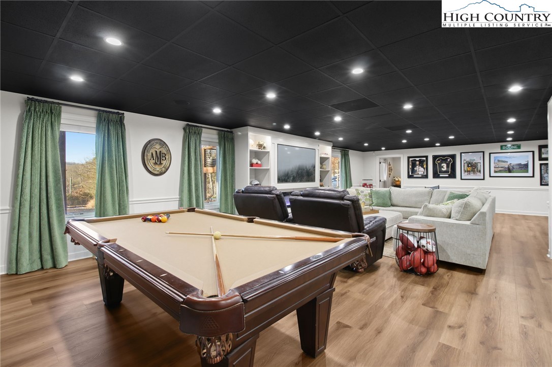 140 Gentry Road Boone, NC 28607 - Photo 31 of 49 a living room with pool table and a wooden floor