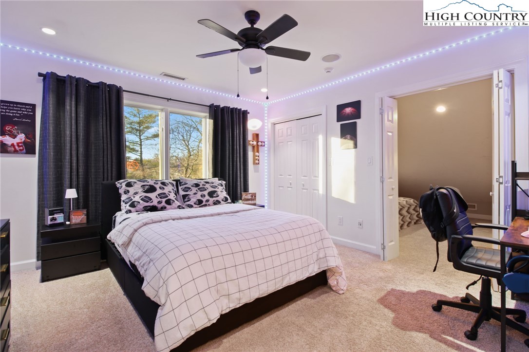 140 Gentry Road Boone, NC 28607 - Photo 40 of 49 a bedroom with a bed a desk and chair