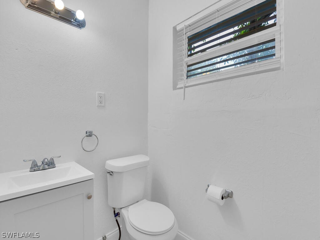 915 Alderman Street Fort Myers, FL 33916 - Photo 17 of 20 a white toilet sitting next to a sink