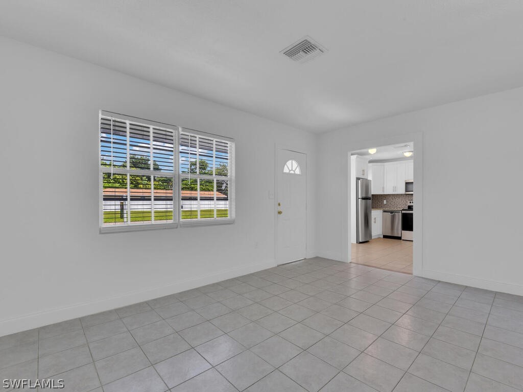 915 Alderman Street Fort Myers, FL 33916 - Photo 5 of 20 a view of empty room with wooden floor and windows