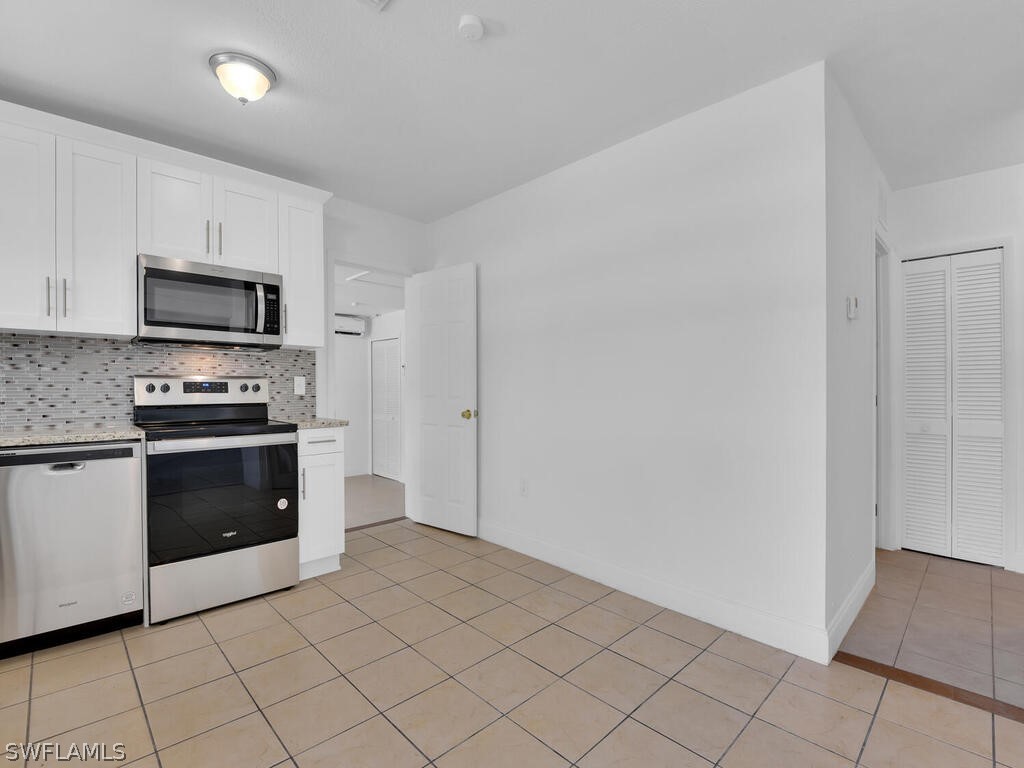 915 Alderman Street Fort Myers, FL 33916 - Photo 7 of 20 a kitchen with a sink and a stove top oven