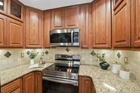 a kitchen with a sink a stove and cabinets