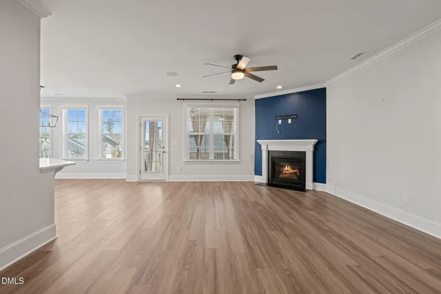 a open kitchen with stainless steel appliances granite countertop a stove a sink dishwasher a refrigerator and a oven with wooden floor