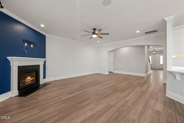 a view of an empty room with window and closet area