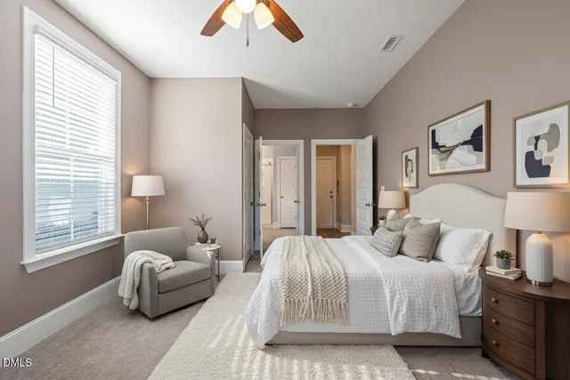 a view of an empty room with a fireplace and a window