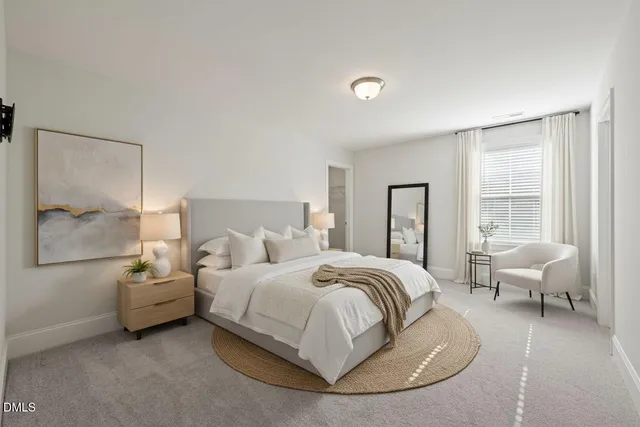 a view of an empty room with wooden floor fireplace and a window