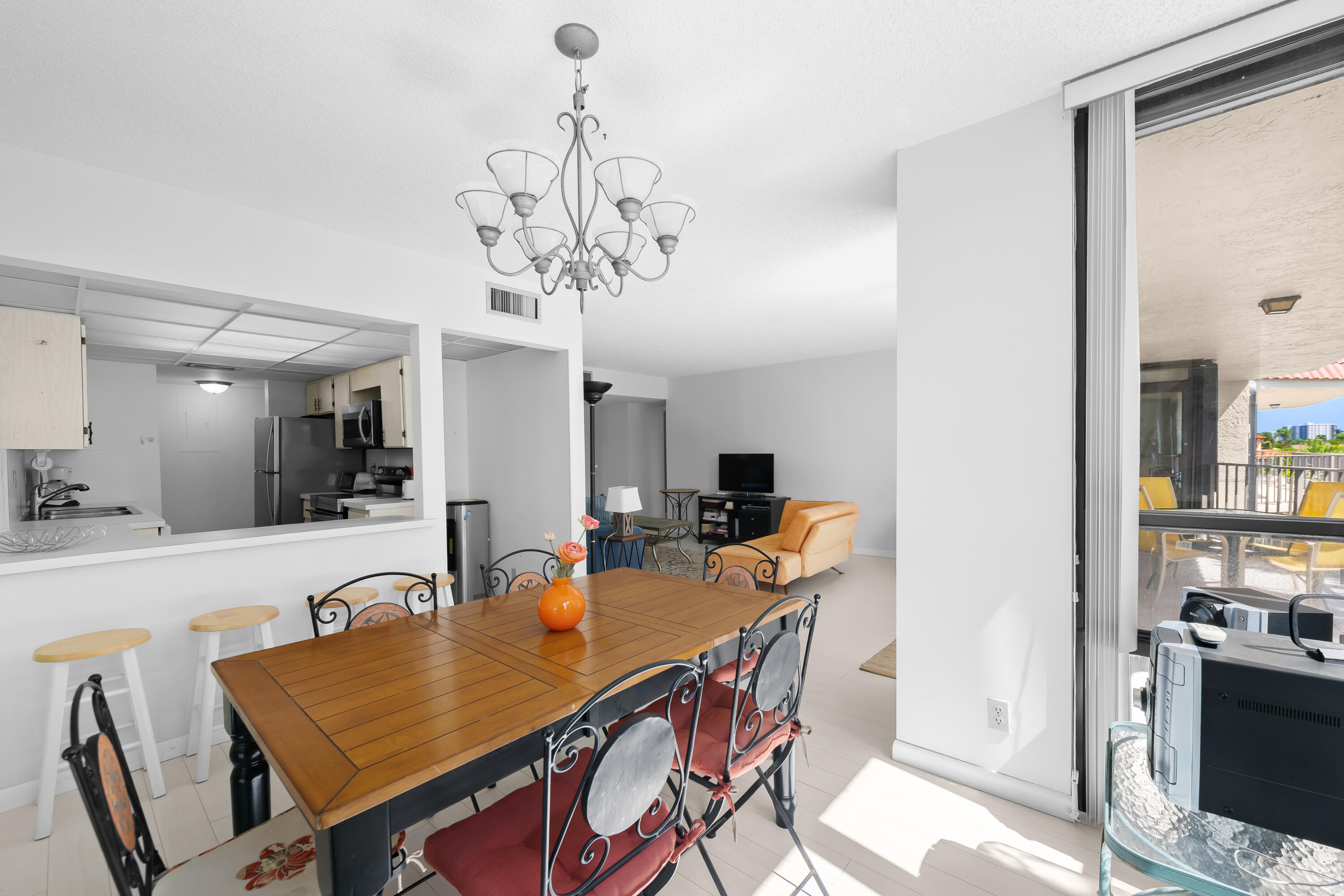 799 Jeffery Street, Unit 411 Boca Raton, FL 33487 - Photo 11 of 37 a view of a dining room with furniture and chandelier