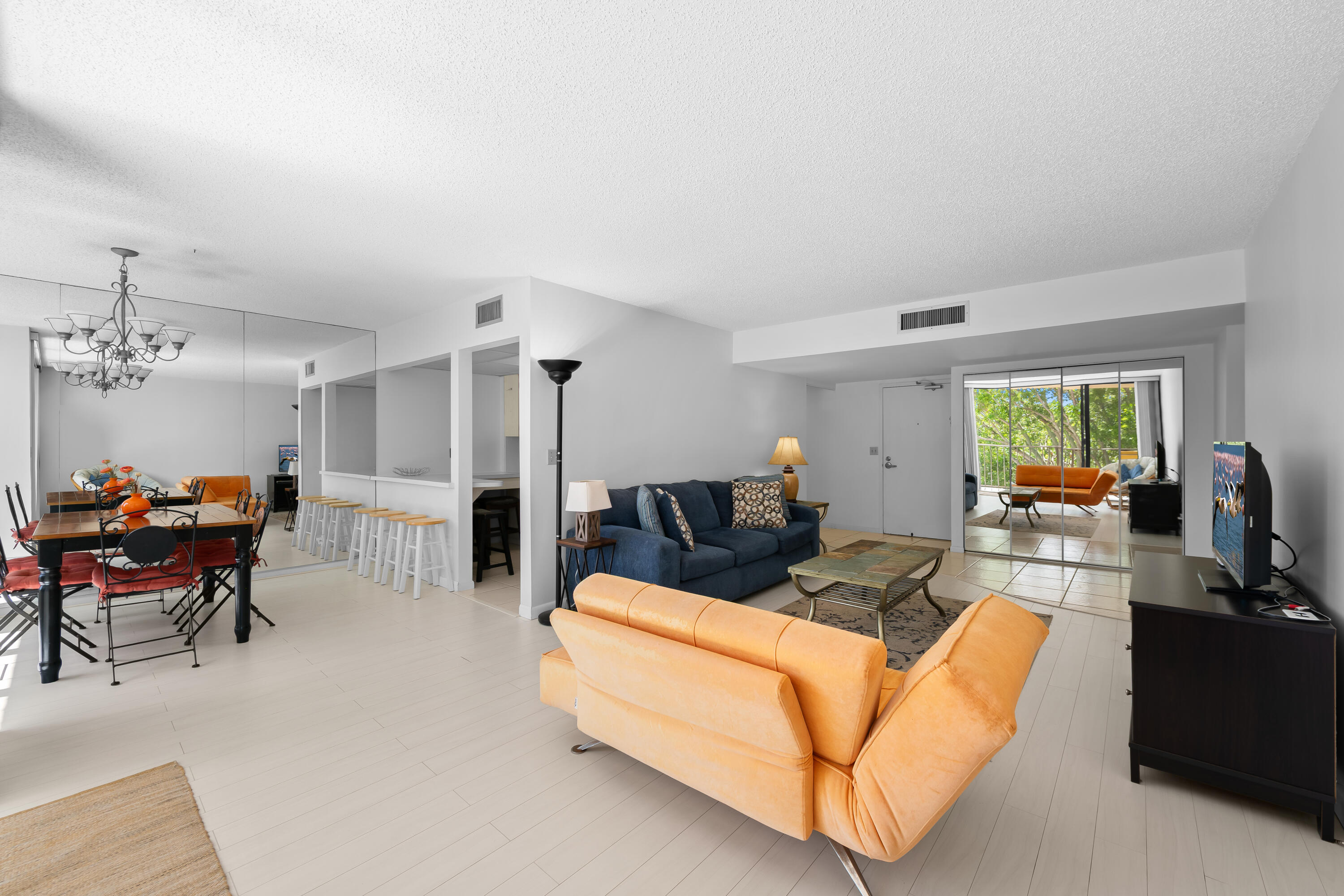 799 Jeffery Street, Unit 411 Boca Raton, FL 33487 - Photo 13 of 37 a living room with furniture and a flat screen tv