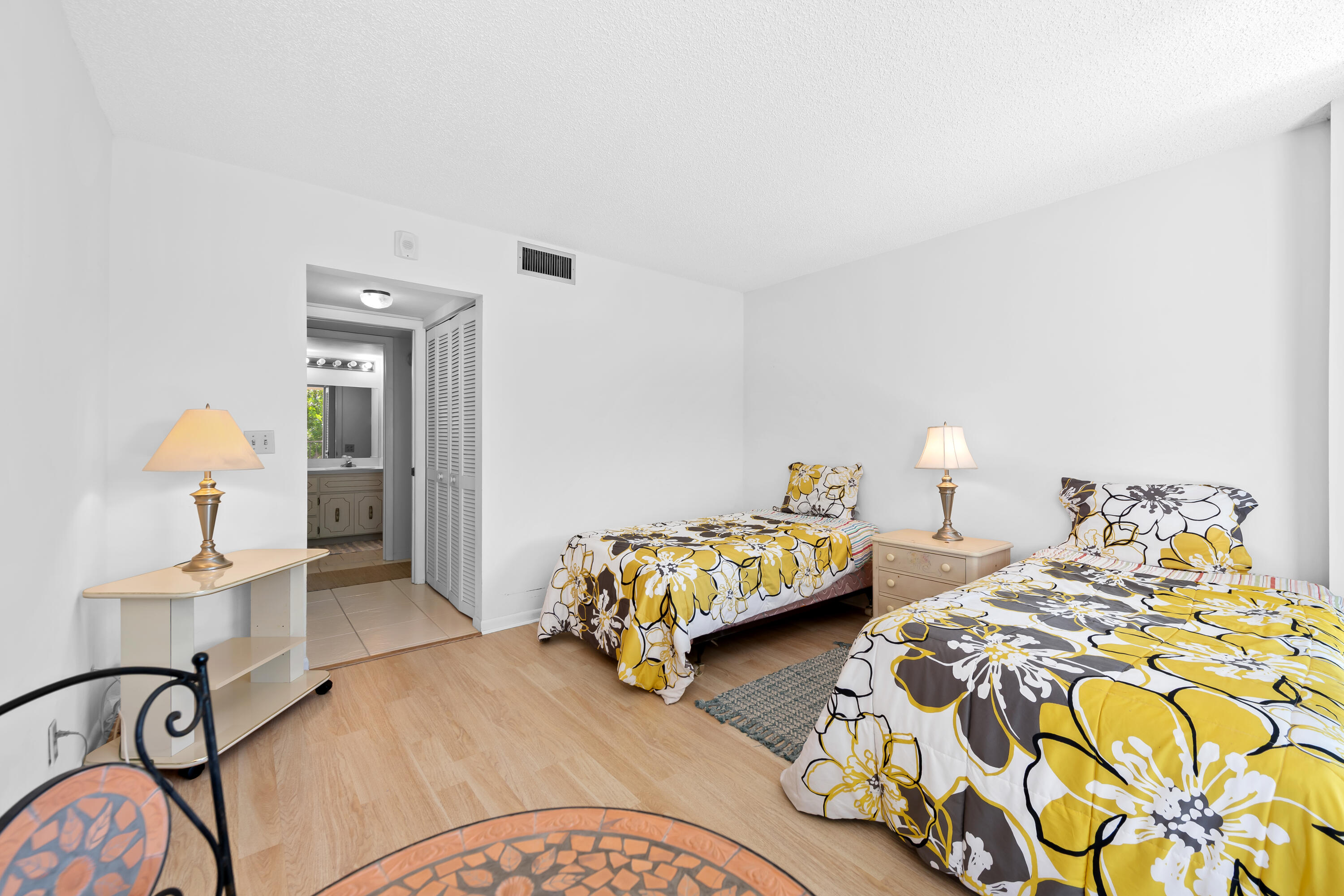 799 Jeffery Street, Unit 411 Boca Raton, FL 33487 - Photo 16 of 37 a bedroom with two beds and painting on the wall