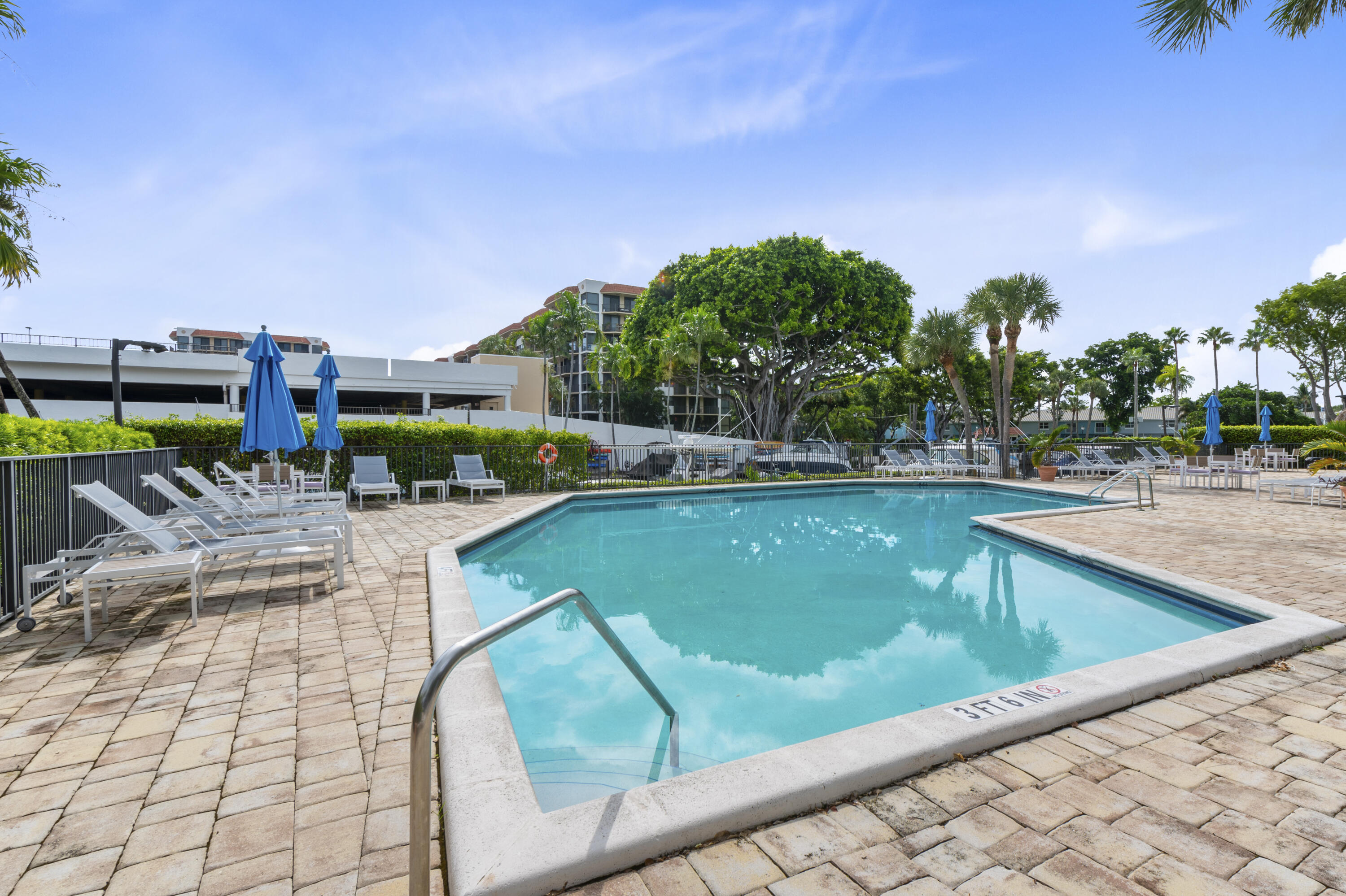 799 Jeffery Street, Unit 411 Boca Raton, FL 33487 - Photo 32 of 37 a view of swimming pool with outdoor seating and plants