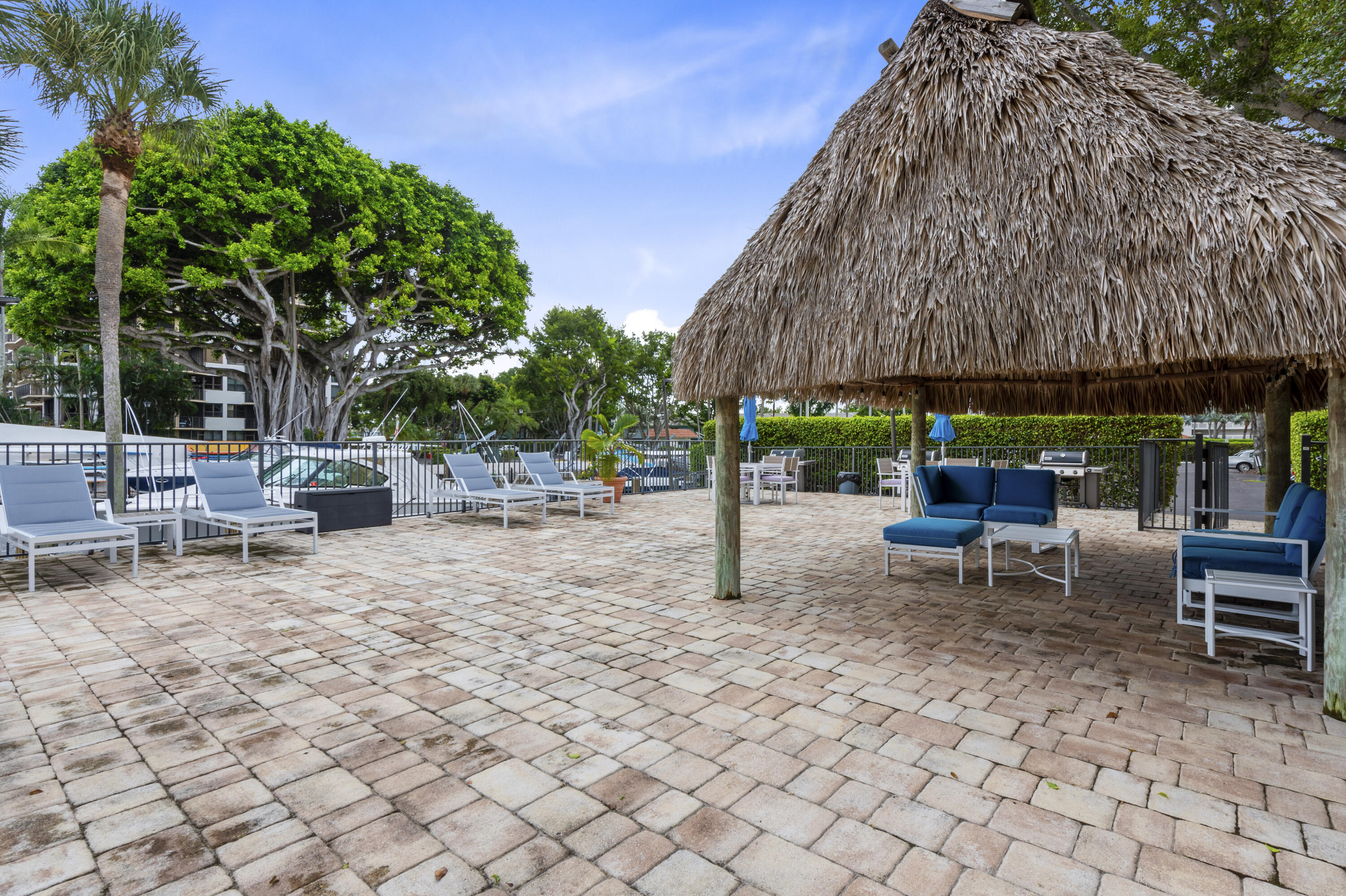 799 Jeffery Street, Unit 411 Boca Raton, FL 33487 - Photo 35 of 37 a view of backyard with table and chairs under an umbrella