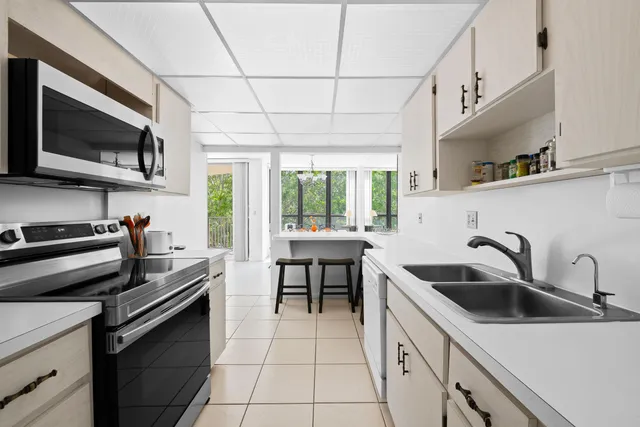 a kitchen with stainless steel appliances a sink a stove and cabinets