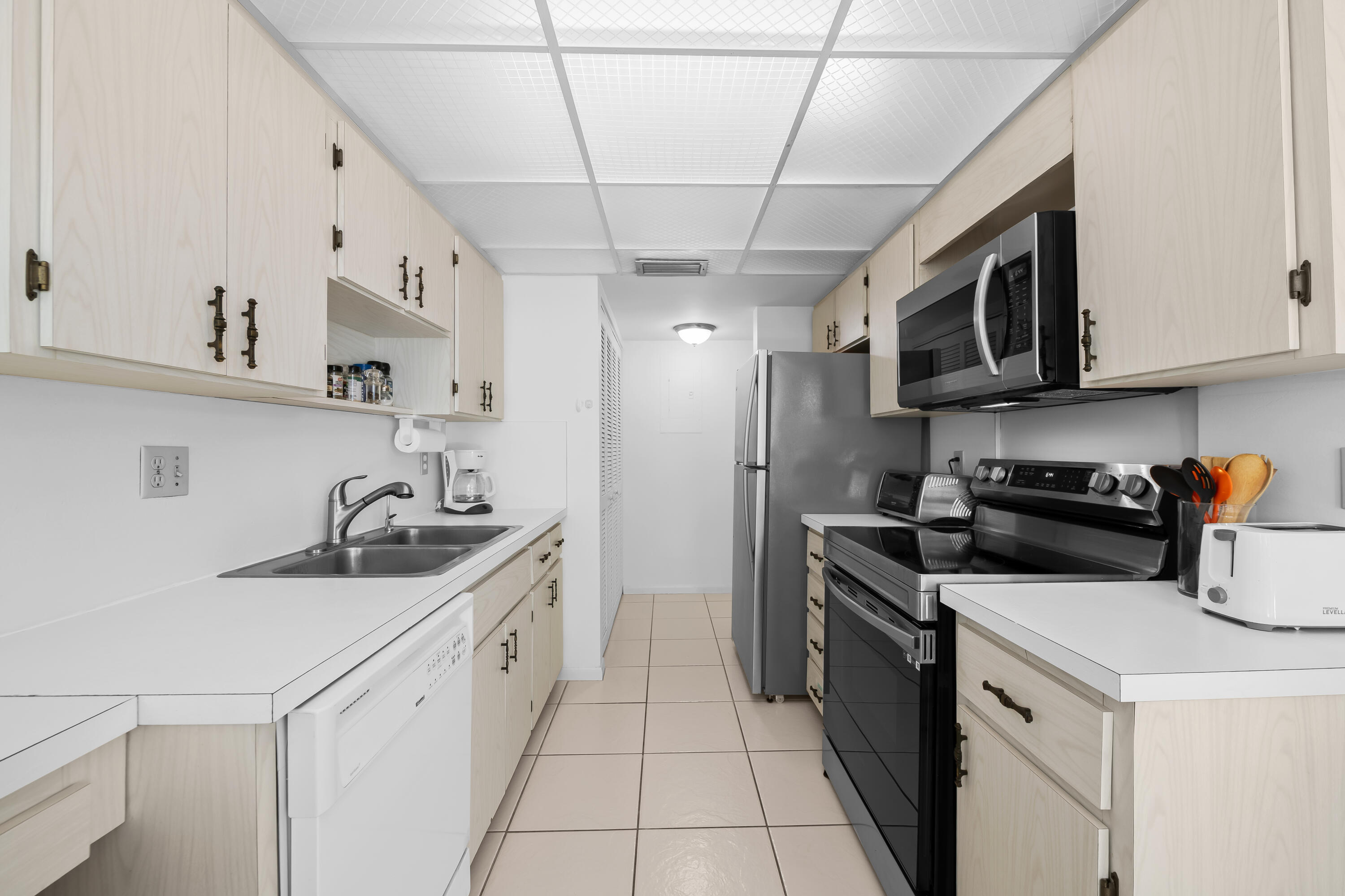 799 Jeffery Street, Unit 411 Boca Raton, FL 33487 - Photo 8 of 37 a kitchen with stainless steel appliances granite countertop a sink stove and refrigerator