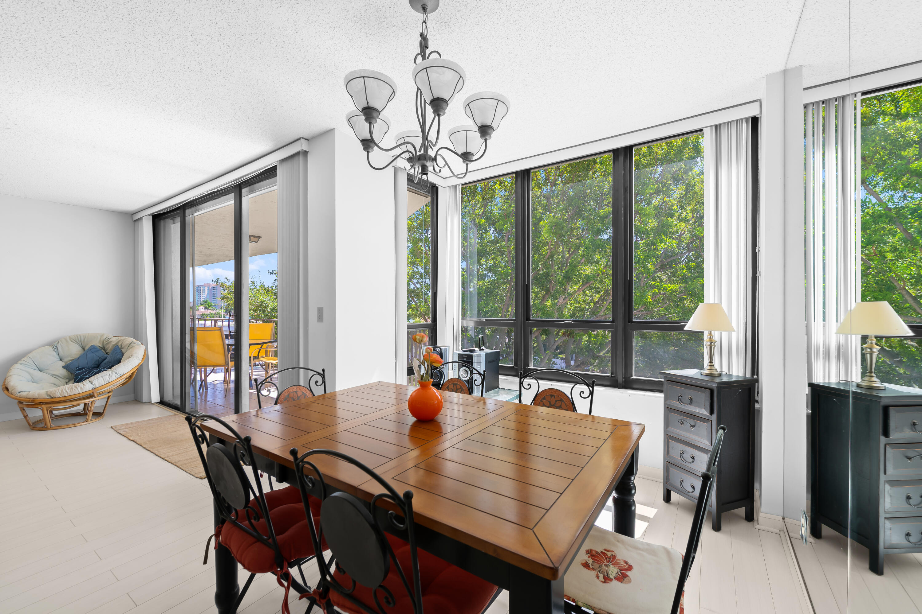 799 Jeffery Street, Unit 411 Boca Raton, FL 33487 - Photo 10 of 37 a dining room with furniture a chandelier and wooden floor