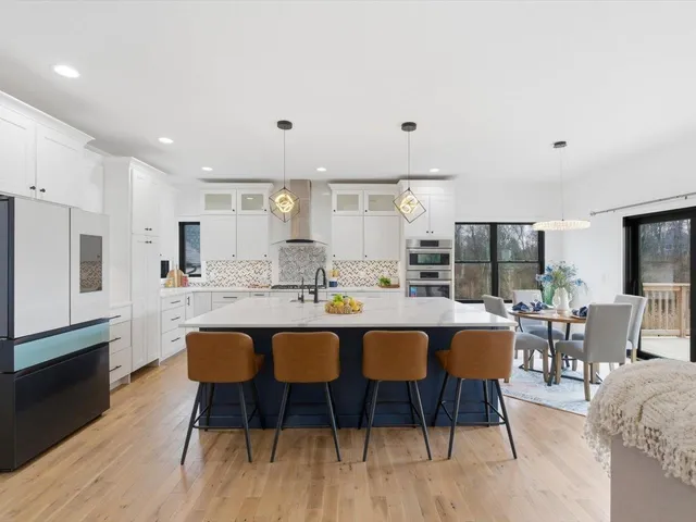 a large kitchen with a table and chairs
