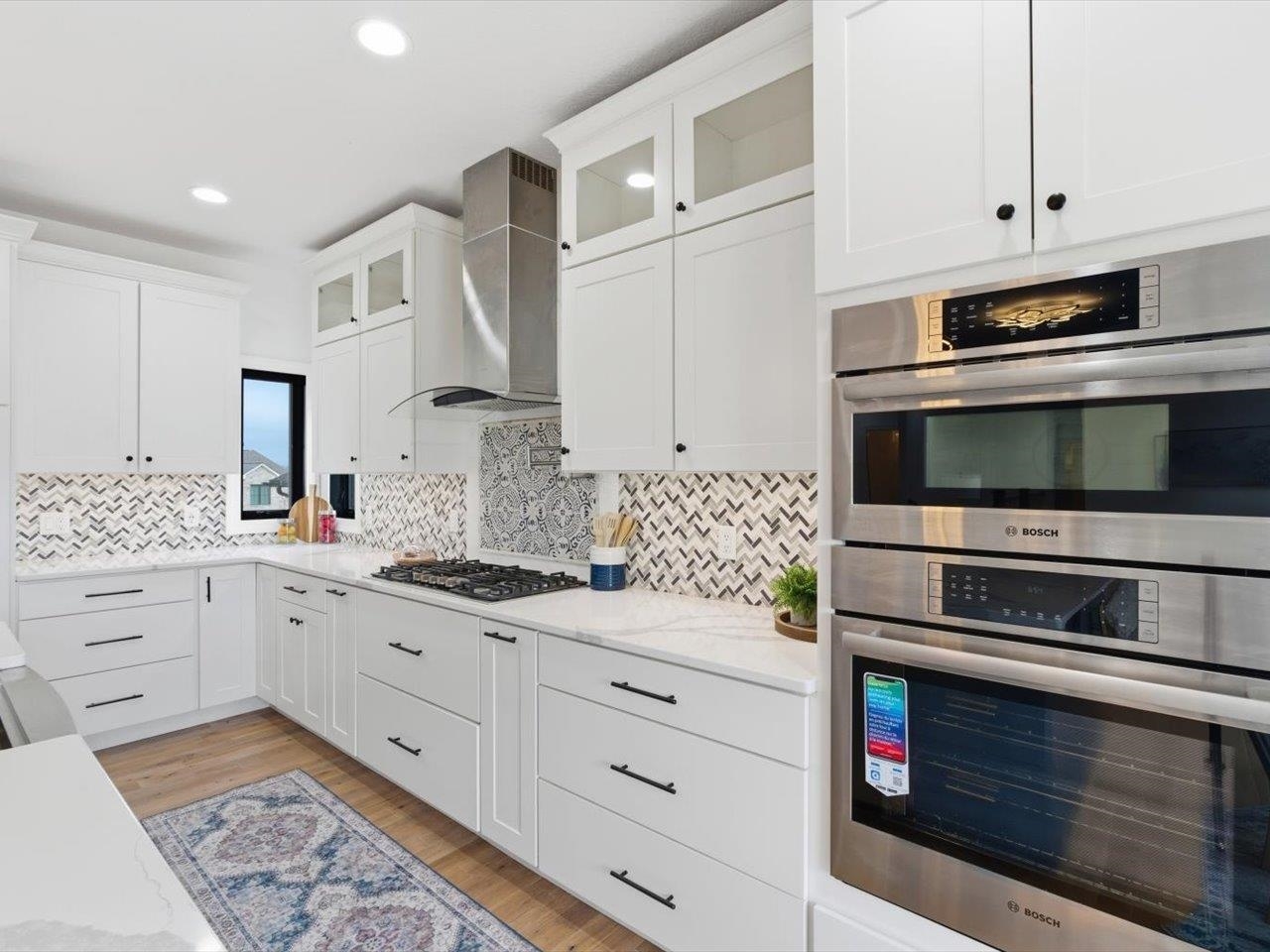 6817 Timber Court Bettendorf, IA 52722 - Photo 16 of 64 a kitchen with granite countertop cabinets stainless steel appliances and sink