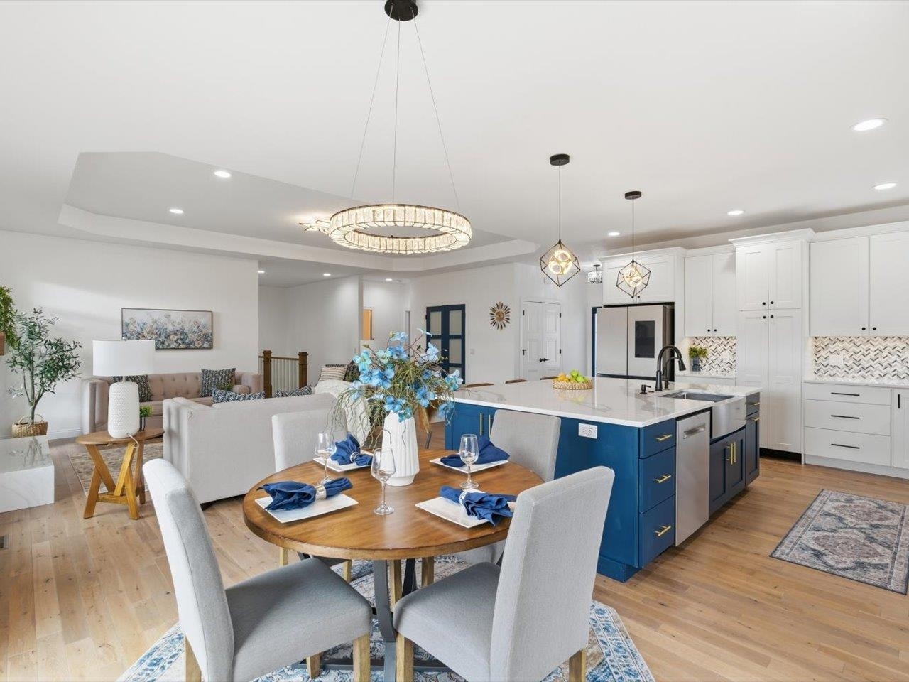 6817 Timber Court Bettendorf, IA 52722 - Photo 19 of 64 a open dining room with stainless steel appliances kitchen island granite countertop a table chairs and a refrigerator