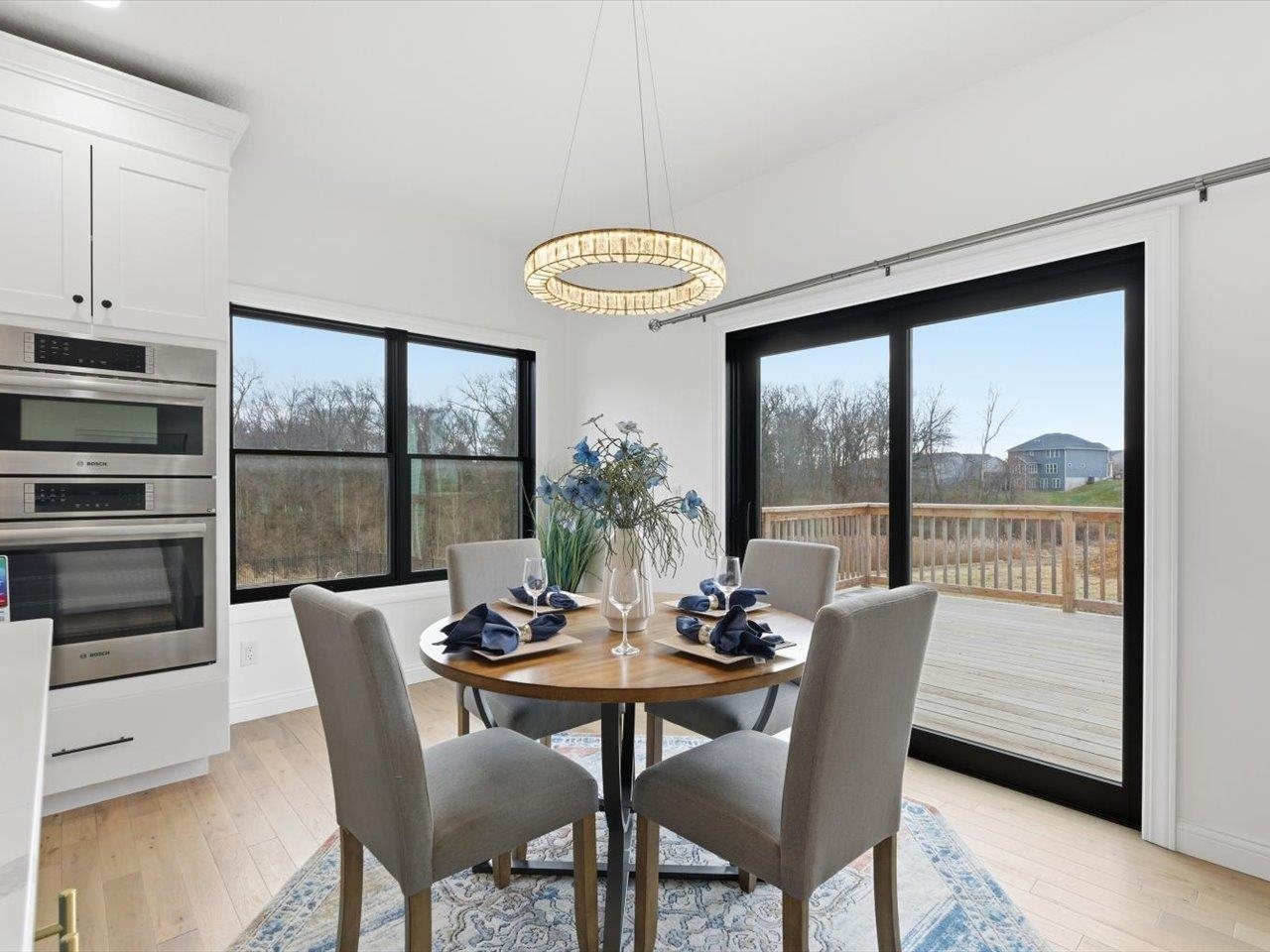 6817 Timber Court Bettendorf, IA 52722 - Photo 20 of 64 a view of a dining room with furniture window and wooden floor