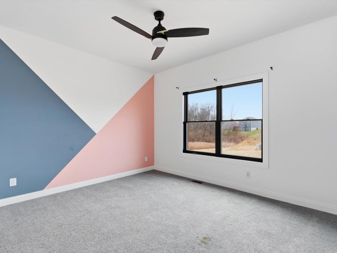 6817 Timber Court Bettendorf, IA 52722 - Photo 35 of 64 an empty room with windows and fan