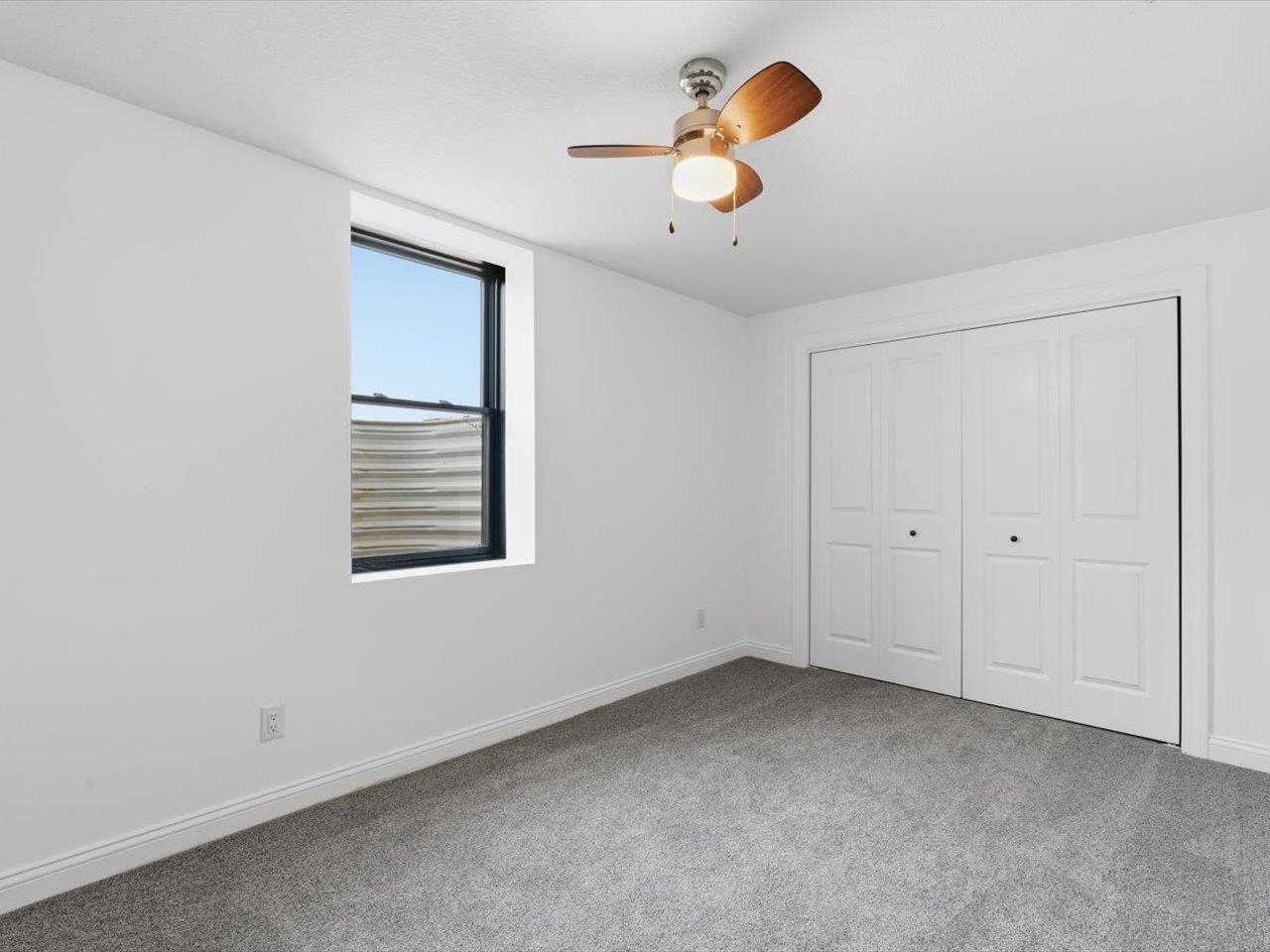 6817 Timber Court Bettendorf, IA 52722 - Photo 47 of 64 an empty room with windows and fan