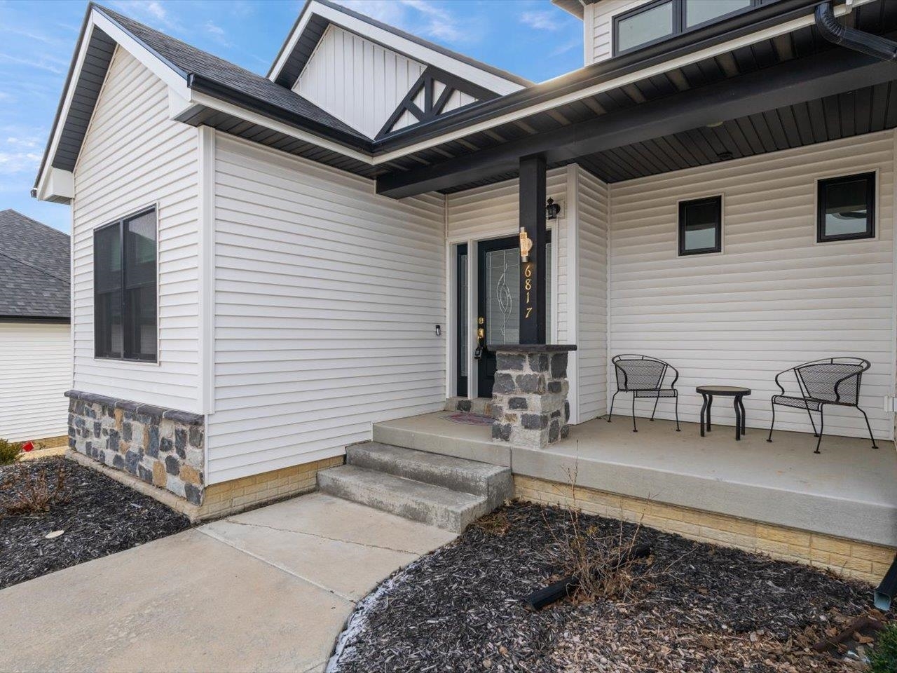 6817 Timber Court Bettendorf, IA 52722 - Photo 5 of 64 a view of a patio with table and chairs with wooden floor and fence
