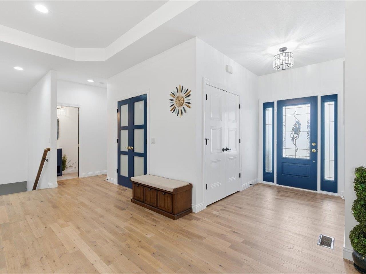 6817 Timber Court Bettendorf, IA 52722 - Photo 6 of 64 a spacious bedroom with a large bed and a chandelier
