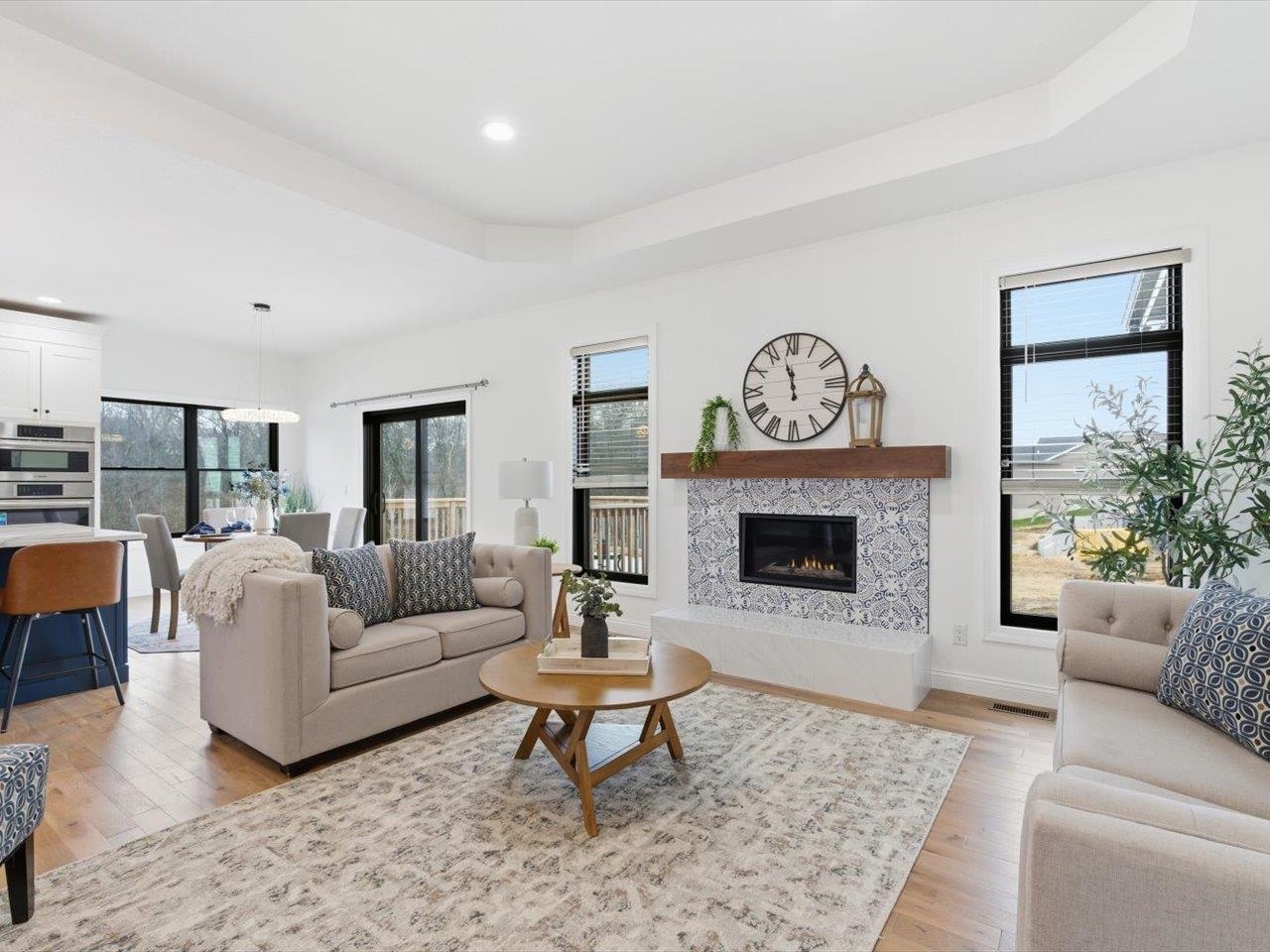 6817 Timber Court Bettendorf, IA 52722 - Photo 8 of 64 a living room with furniture a rug and a fireplace