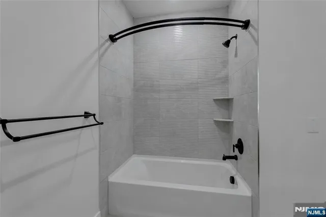 a bathroom with a shower and a bath tub