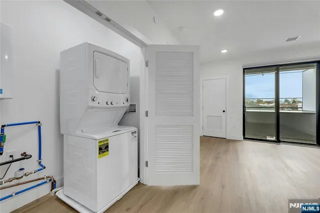 a view of a storage & utility room with two washing machine