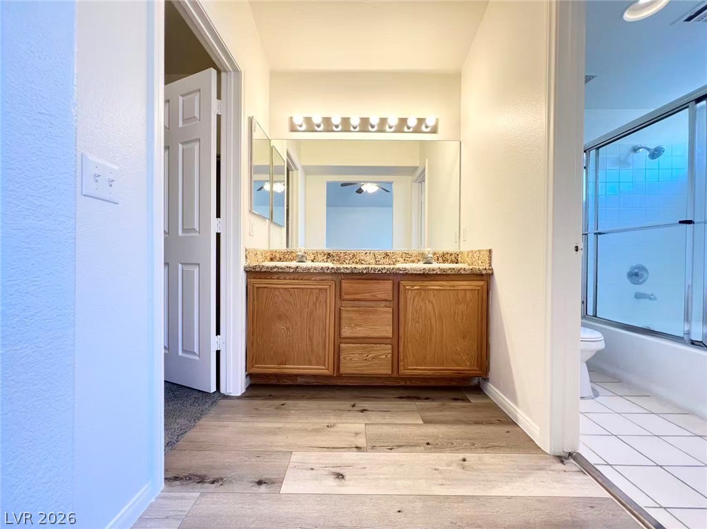 8284 West Rochelle Avenue Las Vegas, NV 89147 - Photo 16 of 29 Double vanity with granite counters and expansive mirror provide generous preparation space.