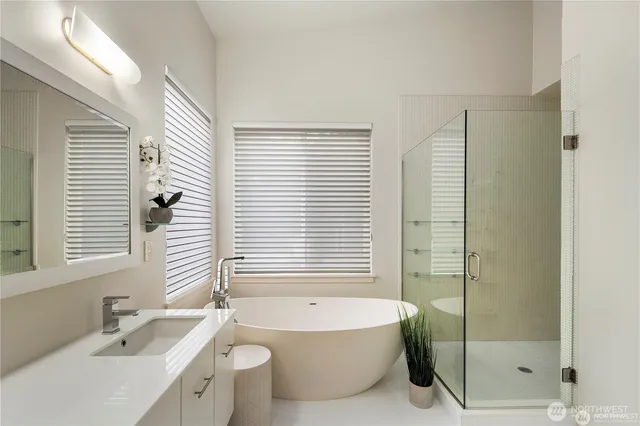 a bathroom with a toilet a sink a mirror a window and vanity