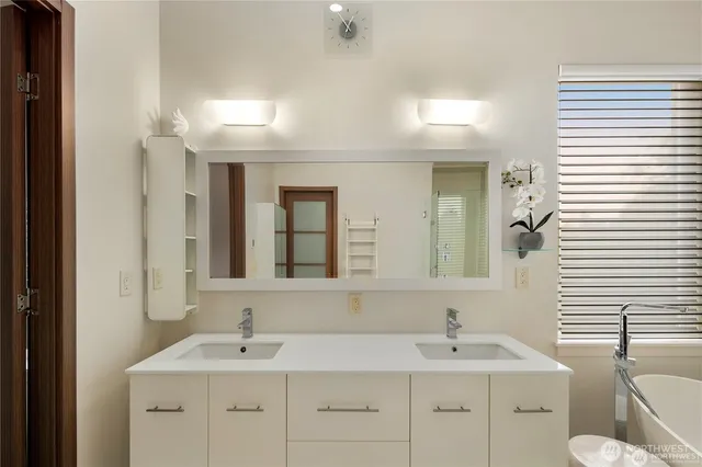 a spacious bathroom with a double vanity sink shower and mirror