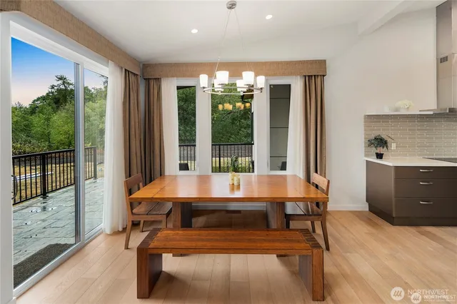 a kitchen with stainless steel appliances a white stove top oven a counter space and a potted plant