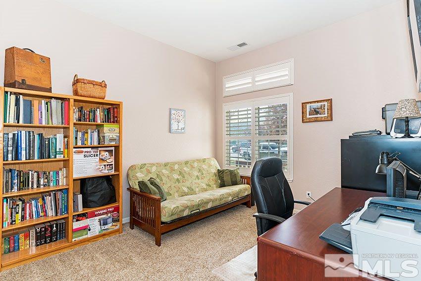 10220 Donnay Court Reno, NV 89521 - Photo 13 of 19 a living room with furniture a book shelf and a window