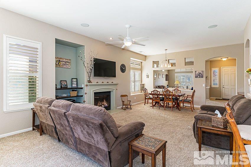 10220 Donnay Court Reno, NV 89521 - Photo 6 of 19 a living room with furniture a fireplace and a flat screen tv