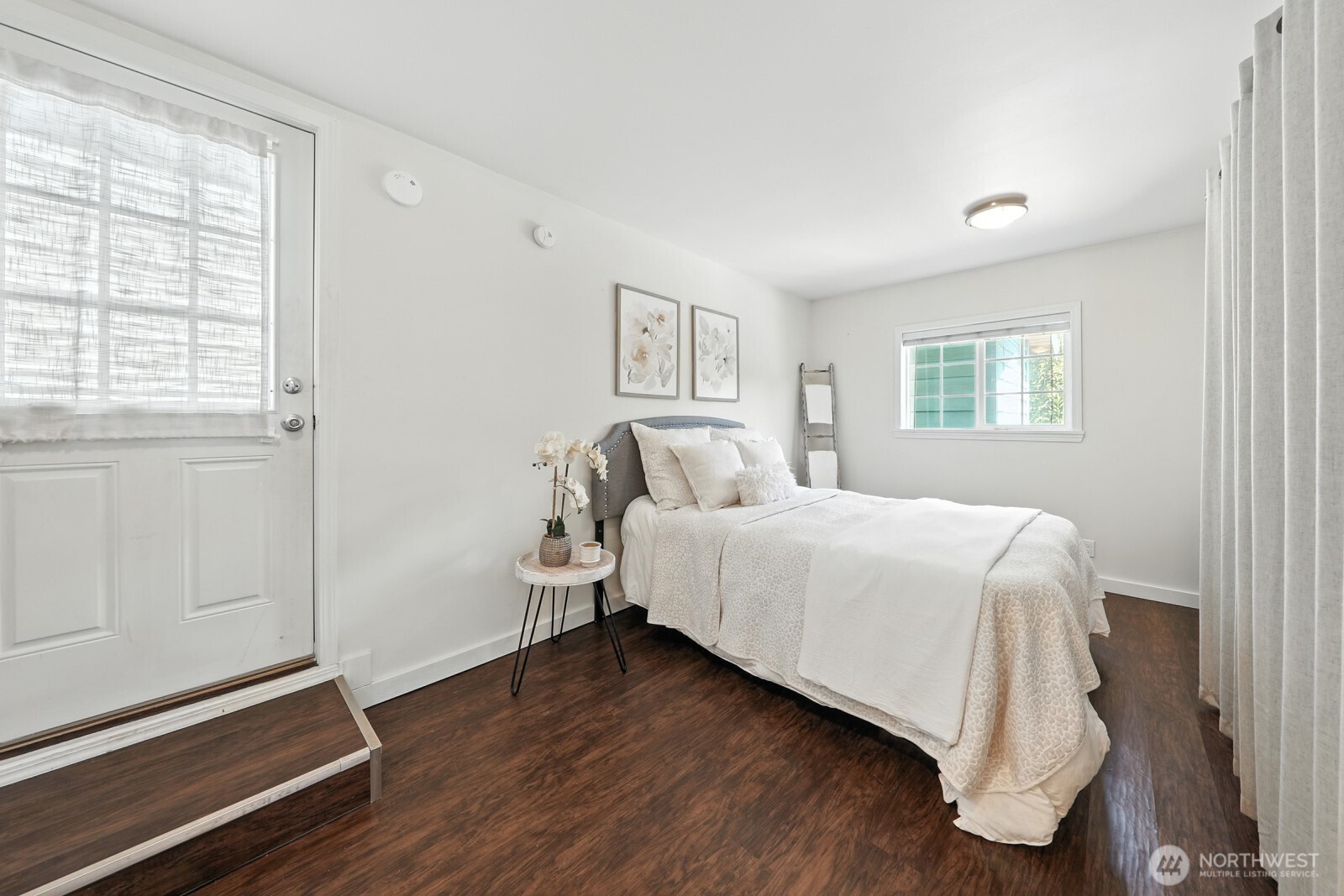 805 36th Street Anacortes, WA 98221 - Photo 17 of 39 a bedroom with a bed and wooden floor