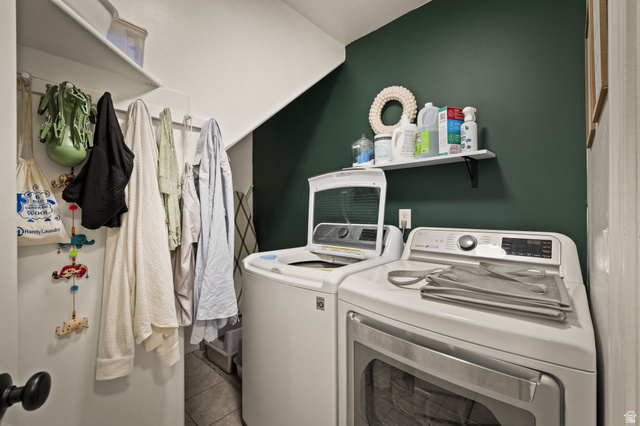 204 Lyman Lane Bountiful, UT 84010 - Photo 22 of 28 Dedicated laundry space featuring a rich green accent wall, white cabinetry, a built-in shelving unit, and tile flooring