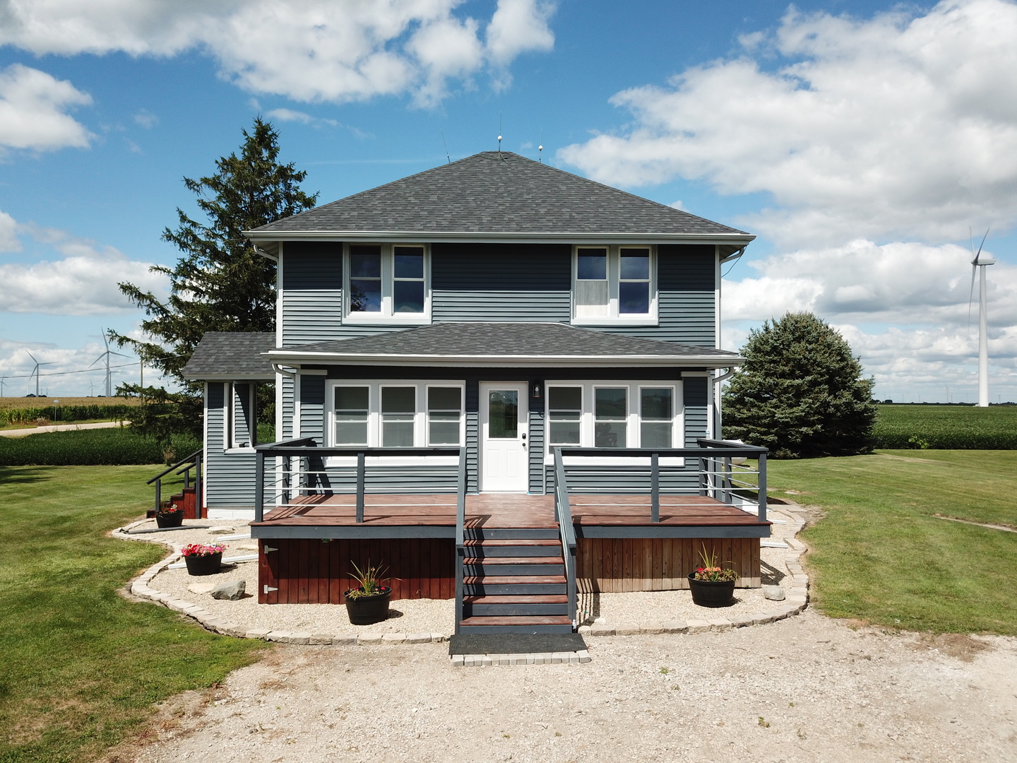 10640 South Johnny Run Road Kinsman, IL 60437 - Photo 1 of 19 a front view of a house with a garden and sitting area