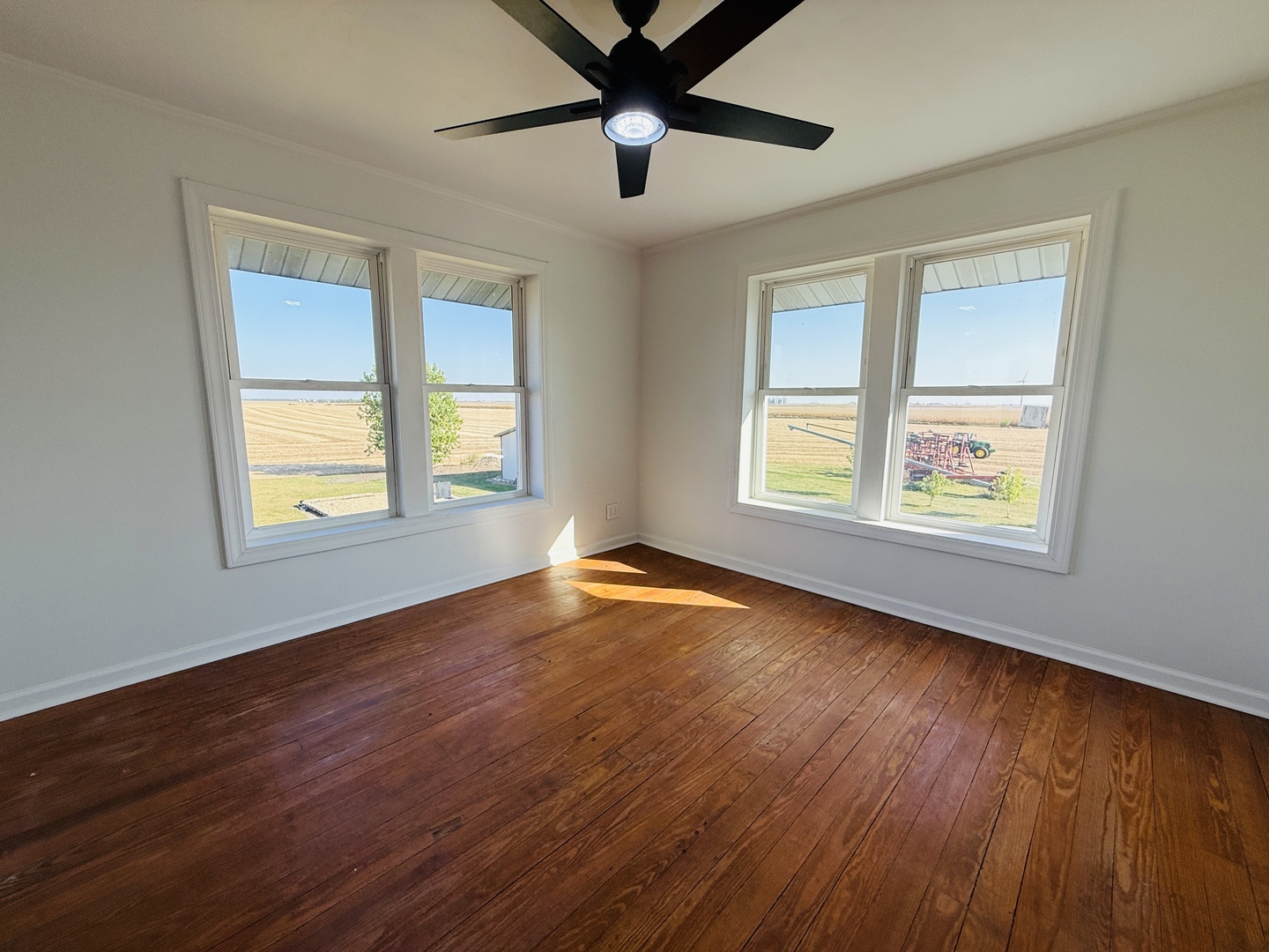 10640 South Johnny Run Road Kinsman, IL 60437 - Photo 13 of 19 a view of an empty room with window and wooden floor