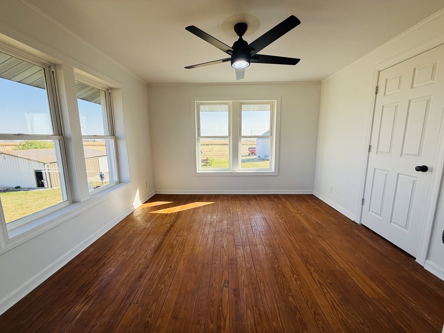 10640 South Johnny Run Road Kinsman, IL 60437 - Photo 14 of 19 a view of empty room with wooden floor and fan