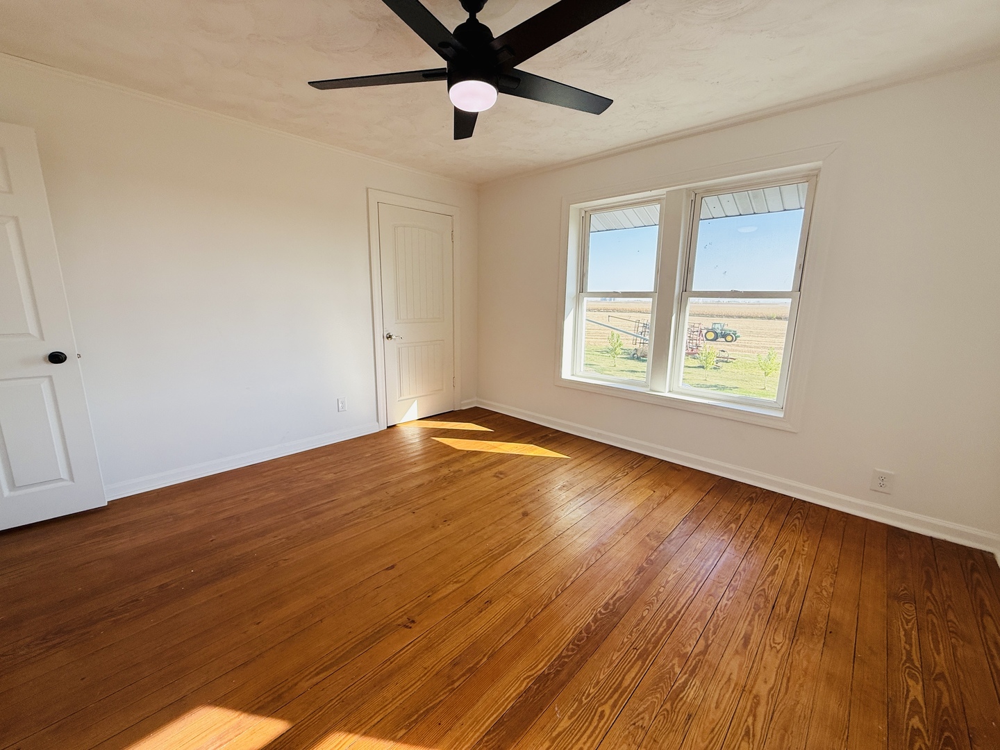 10640 South Johnny Run Road Kinsman, IL 60437 - Photo 15 of 19 a view of an empty room with wooden floor and a window