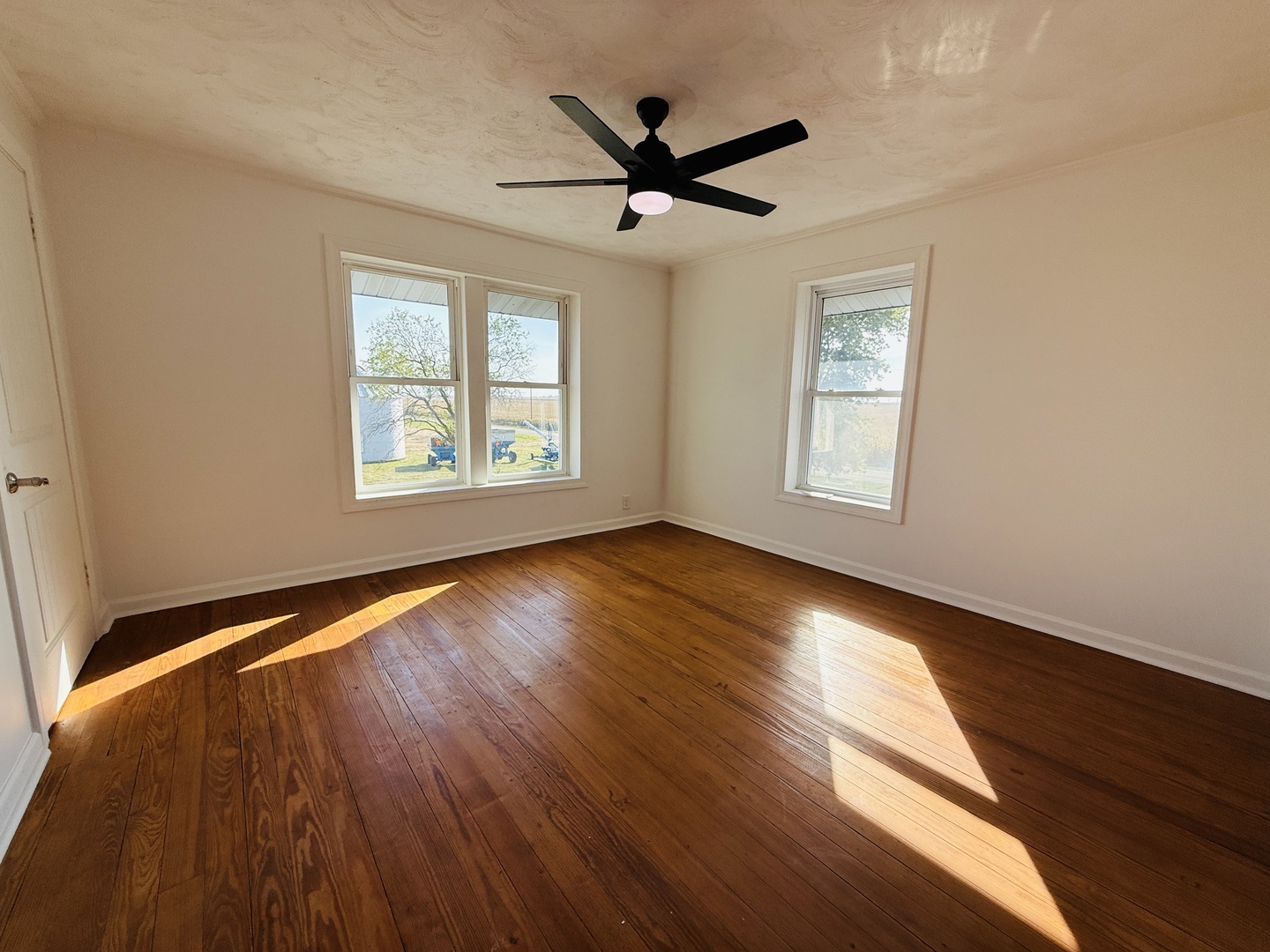 10640 South Johnny Run Road Kinsman, IL 60437 - Photo 16 of 19 a view of empty room with wooden floor and fan