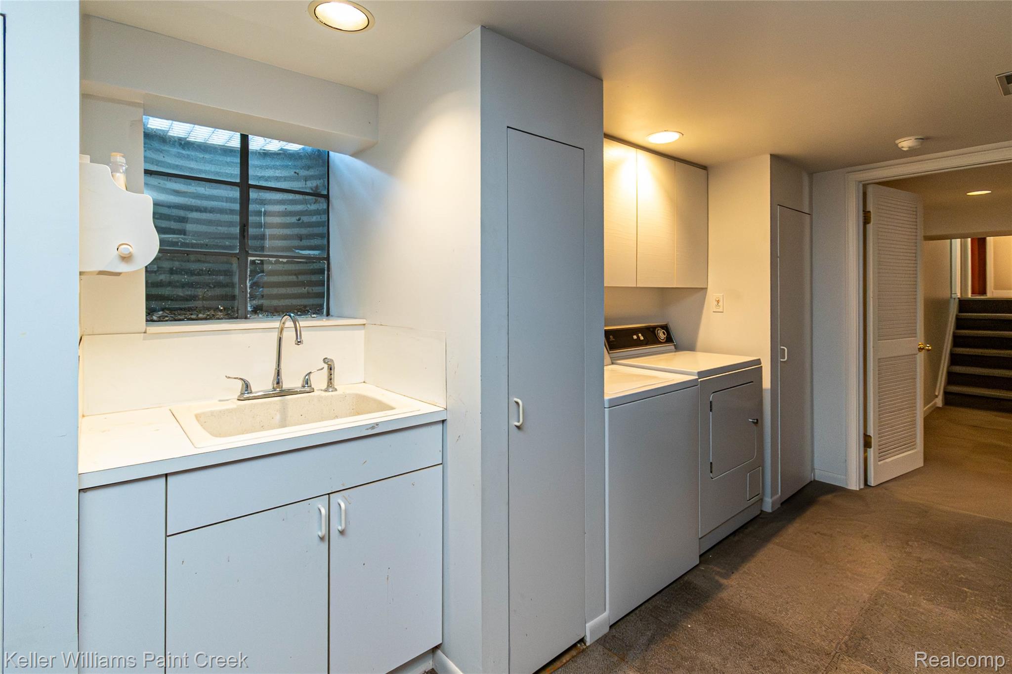 7093 Stonebrook Road West Bloomfield, MI 48322 - Photo 55 of 64 Dedicated laundry area featuring a utility sink with white cabinetry, overhead lighting, and dark flooring