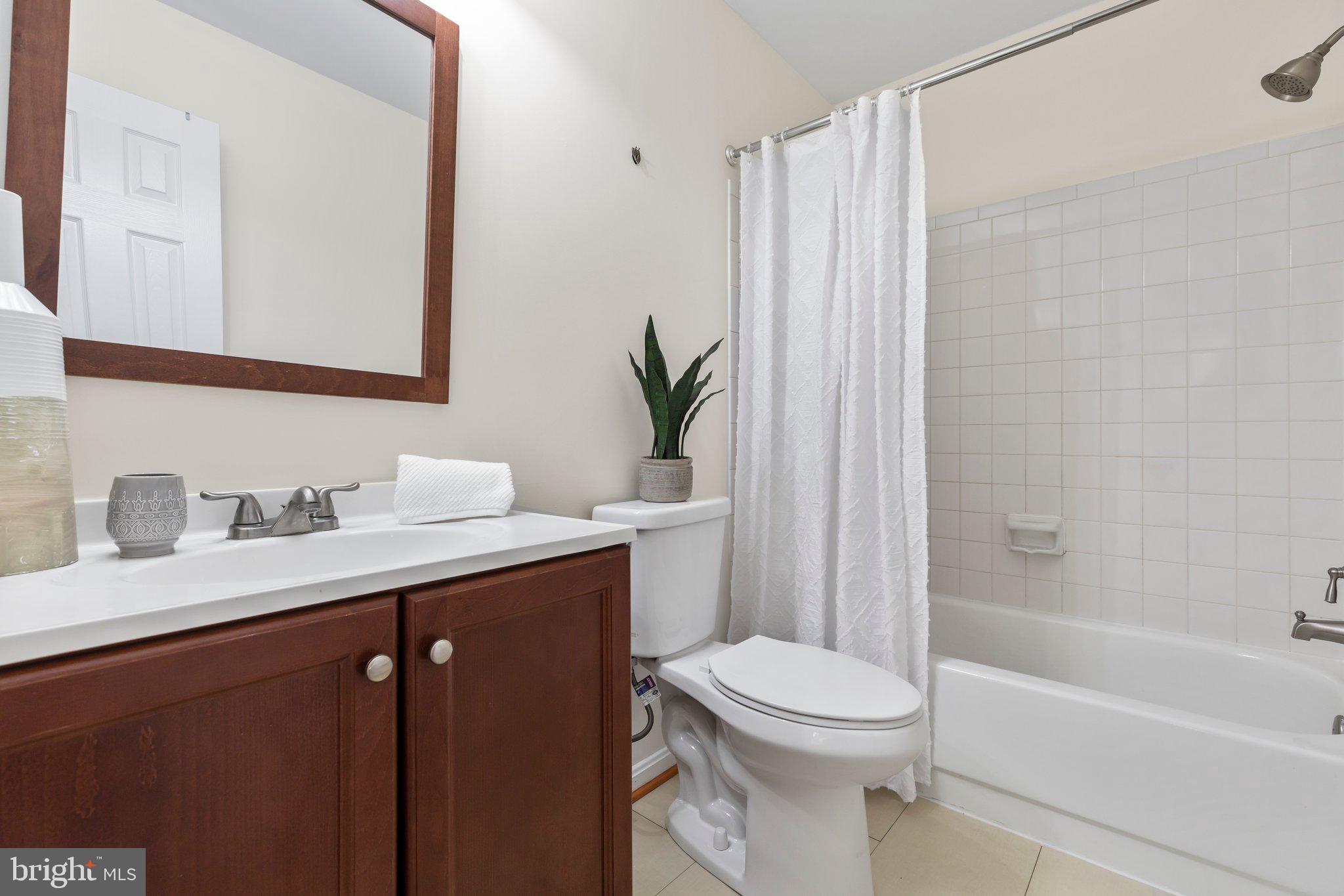 17929 Milroy Drive Dumfries, VA 22026 - Photo 15 of 36 a bathroom with a granite countertop sink toilet and shower