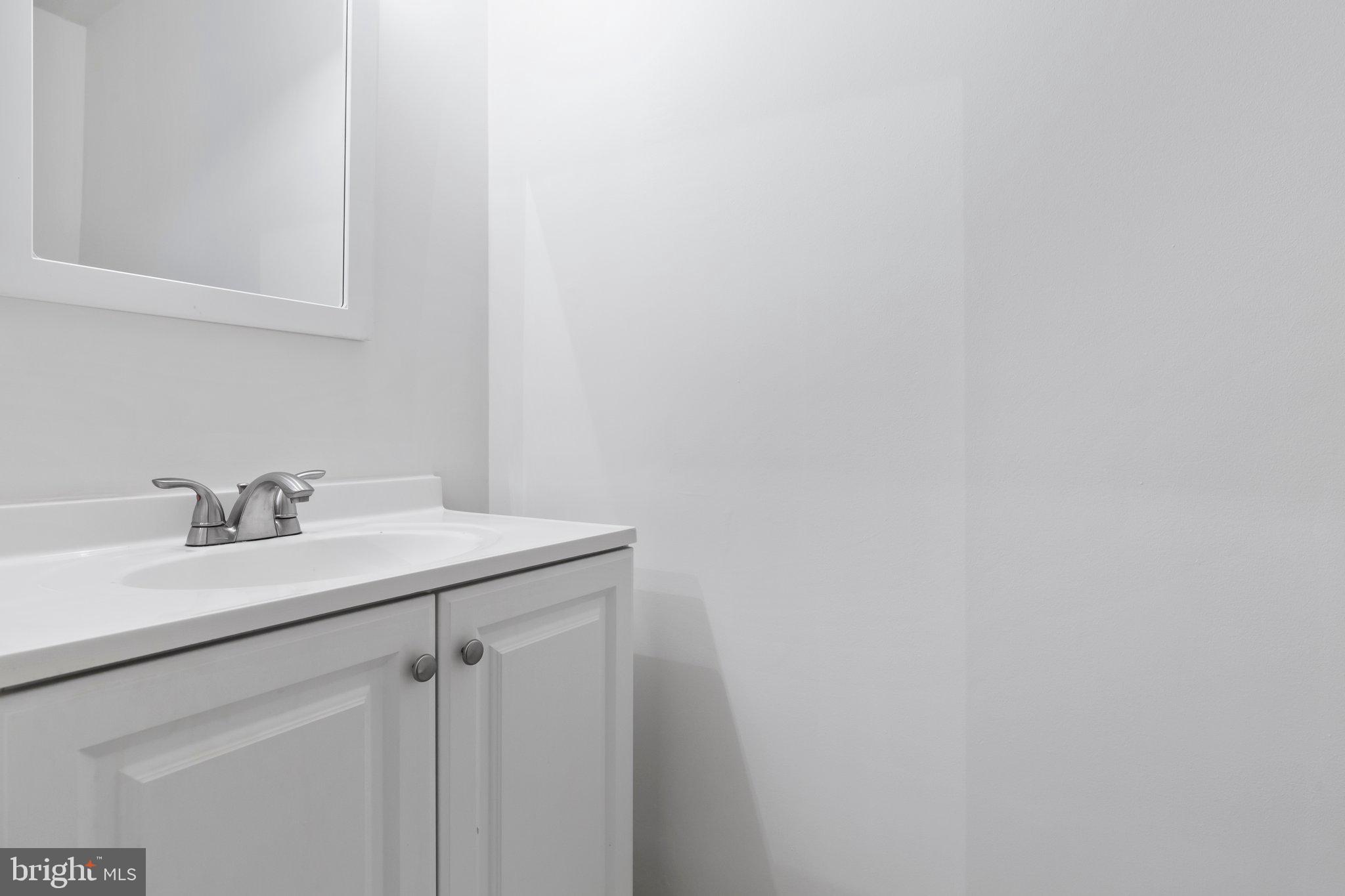 17929 Milroy Drive Dumfries, VA 22026 - Photo 21 of 36 a bathroom with a sink and vanity