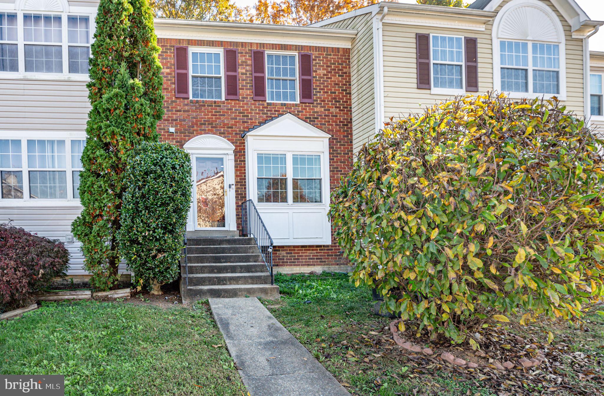 17929 Milroy Drive Dumfries, VA 22026 - Photo 30 of 36 a front view of a house with garden