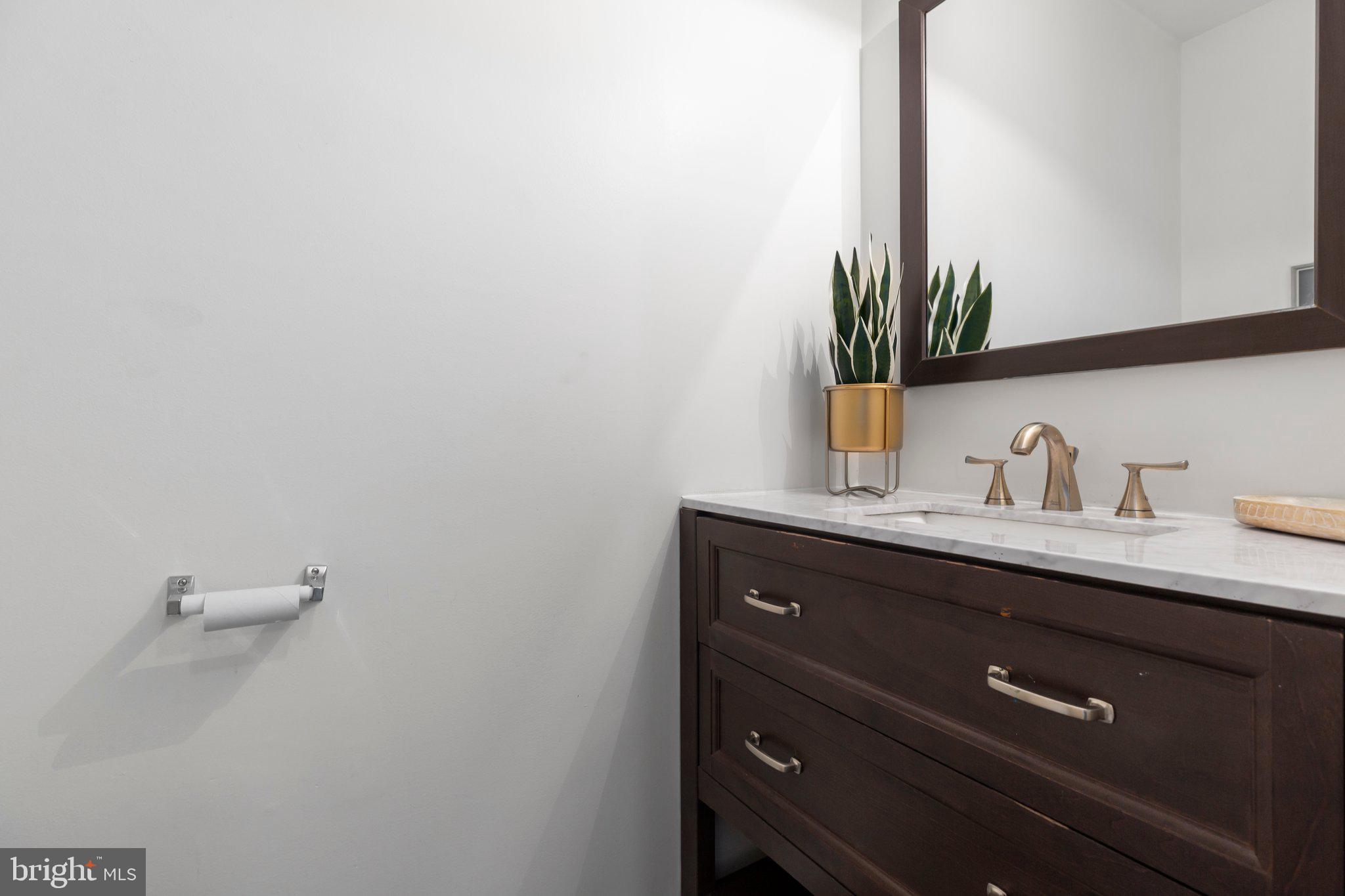 17929 Milroy Drive Dumfries, VA 22026 - Photo 5 of 36 a bathroom with a sink a mirror and vanity