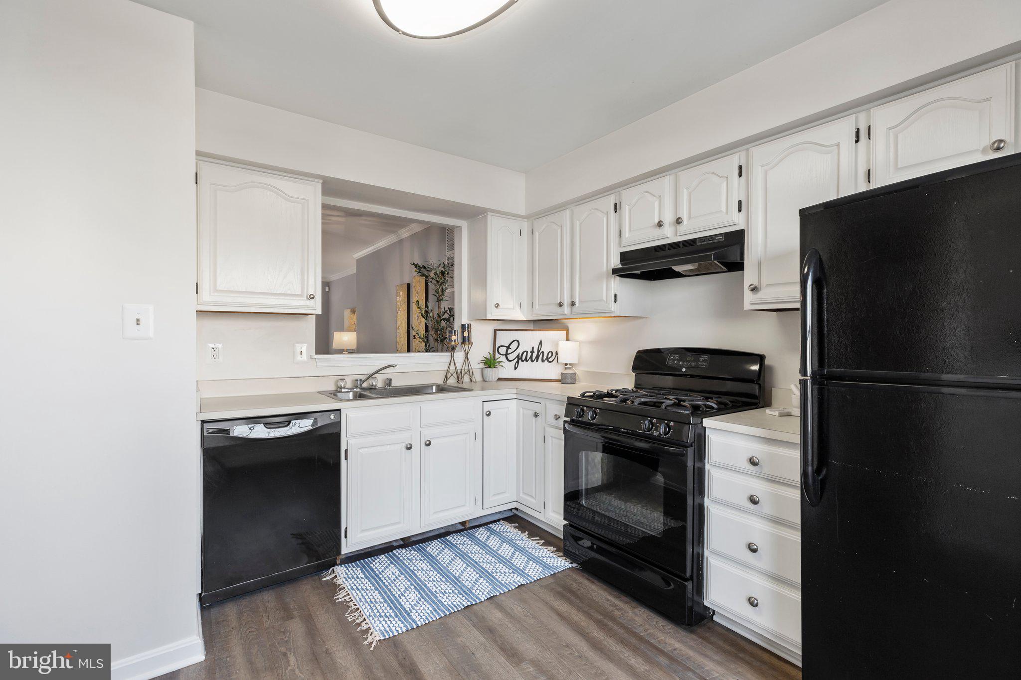 17929 Milroy Drive Dumfries, VA 22026 - Photo 6 of 36 a kitchen with cabinets appliances a sink and a window