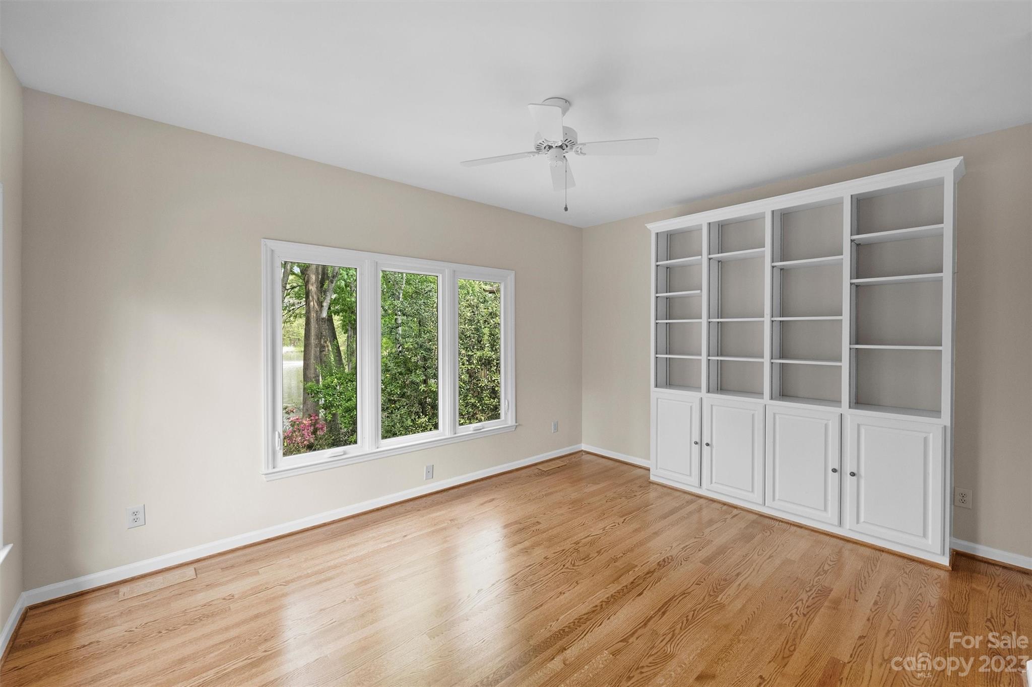 4724 Carson's Pond Road, Unit 104 Charlotte, NC 28226 - Photo 11 of 38 a view of an empty room with wooden floor and a window